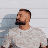 Vadym Stolyarenko looking to the side with a beard, short haircut, and patterned shirt. – Ghar.ie property listing