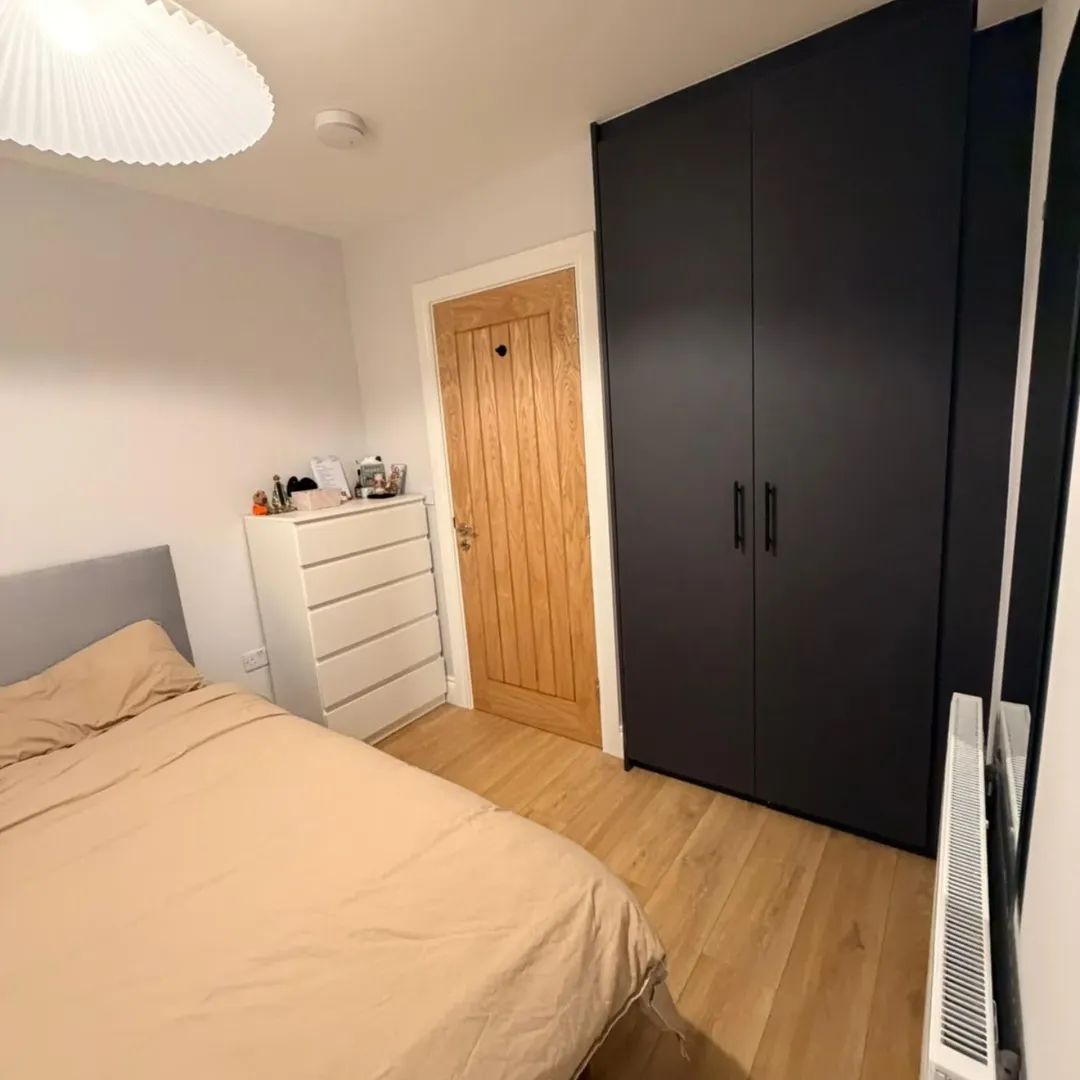 Bedroom Interior Bed Dresser Wardrobe Bedroom interior with bed, dresser, wardrobe, and wooden door.