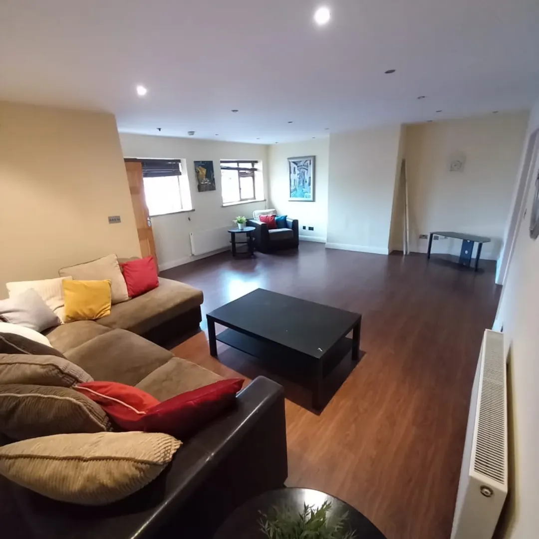 Brown Sectional Sofa Living Room Design Living room with brown sectional sofa, black coffee table, and hardwood floors in a well-lit space.