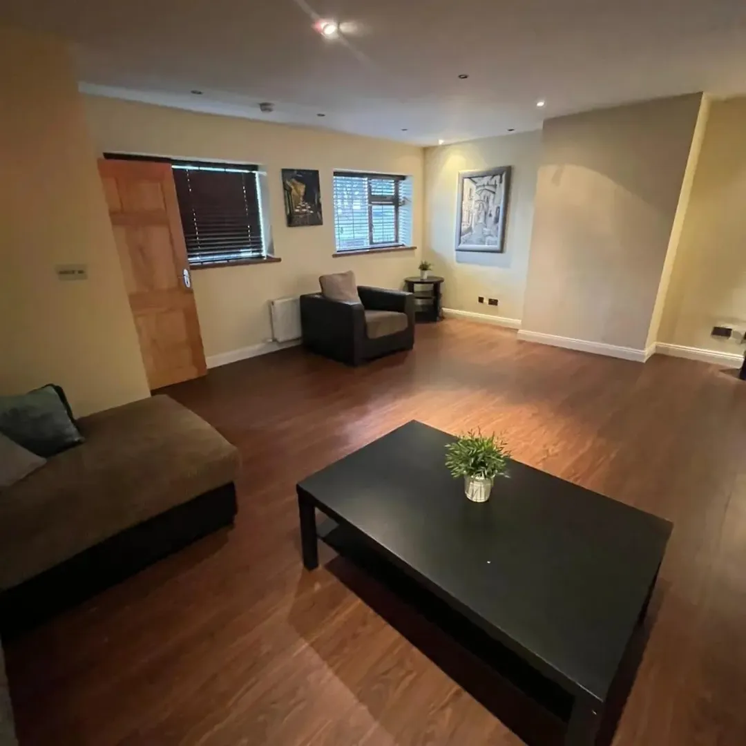 Living Room Brown Sofa Artwork Living room with brown sofa, chair, coffee table, and artwork on the walls.