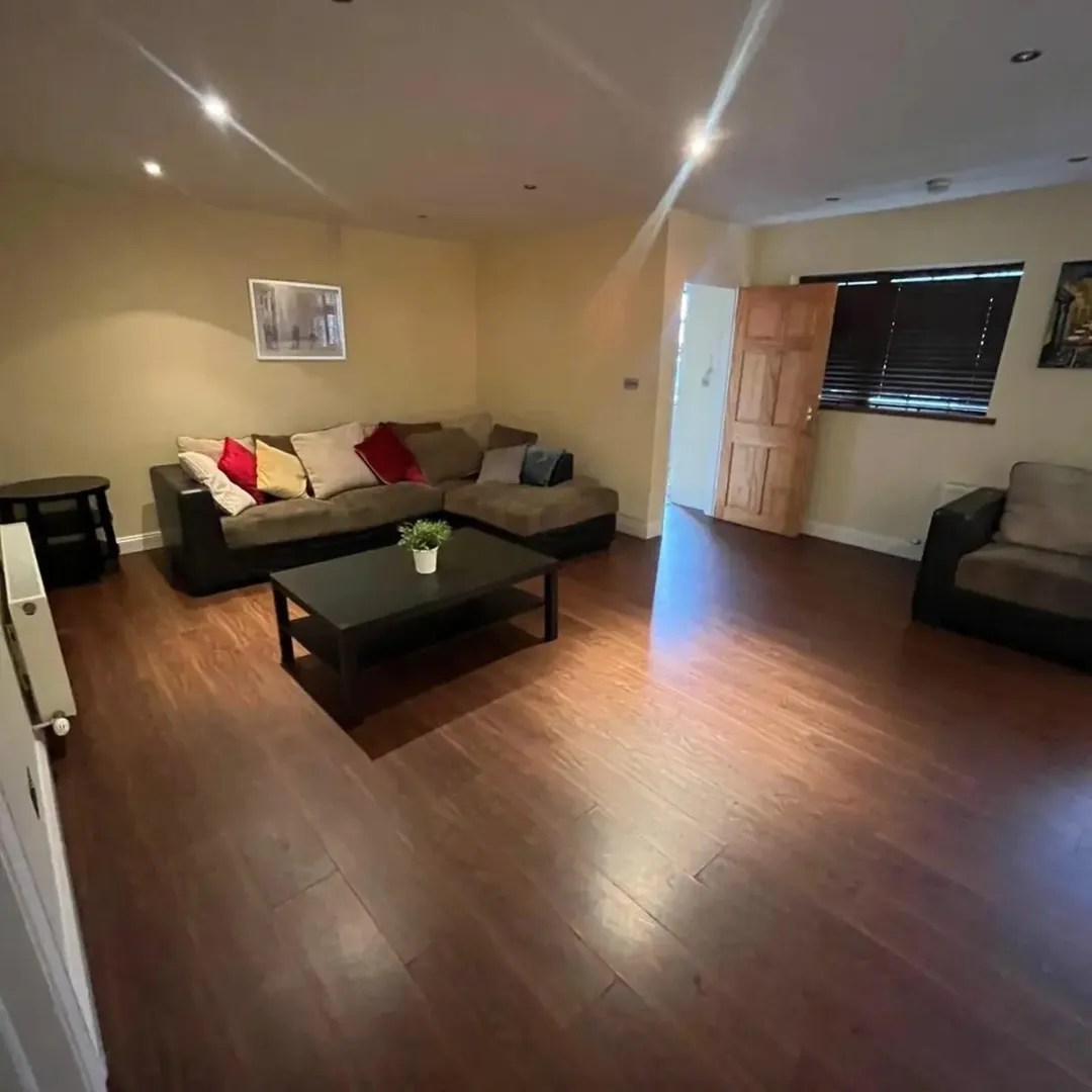 Living Room Brown Sofa Wood Floors Living room with brown sofa, coffee table, and dark wood floors.