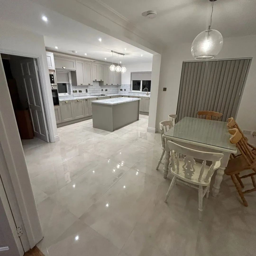 Modern Kitchen Island Dining Area Bright, modern kitchen with island, dining table, and pendant light.