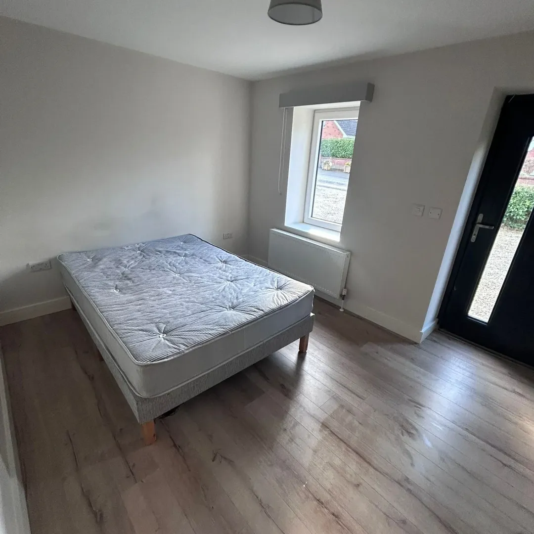 Small Bedroom Bed Window Wood Floor Small bedroom with bed, window, and light wood floors.