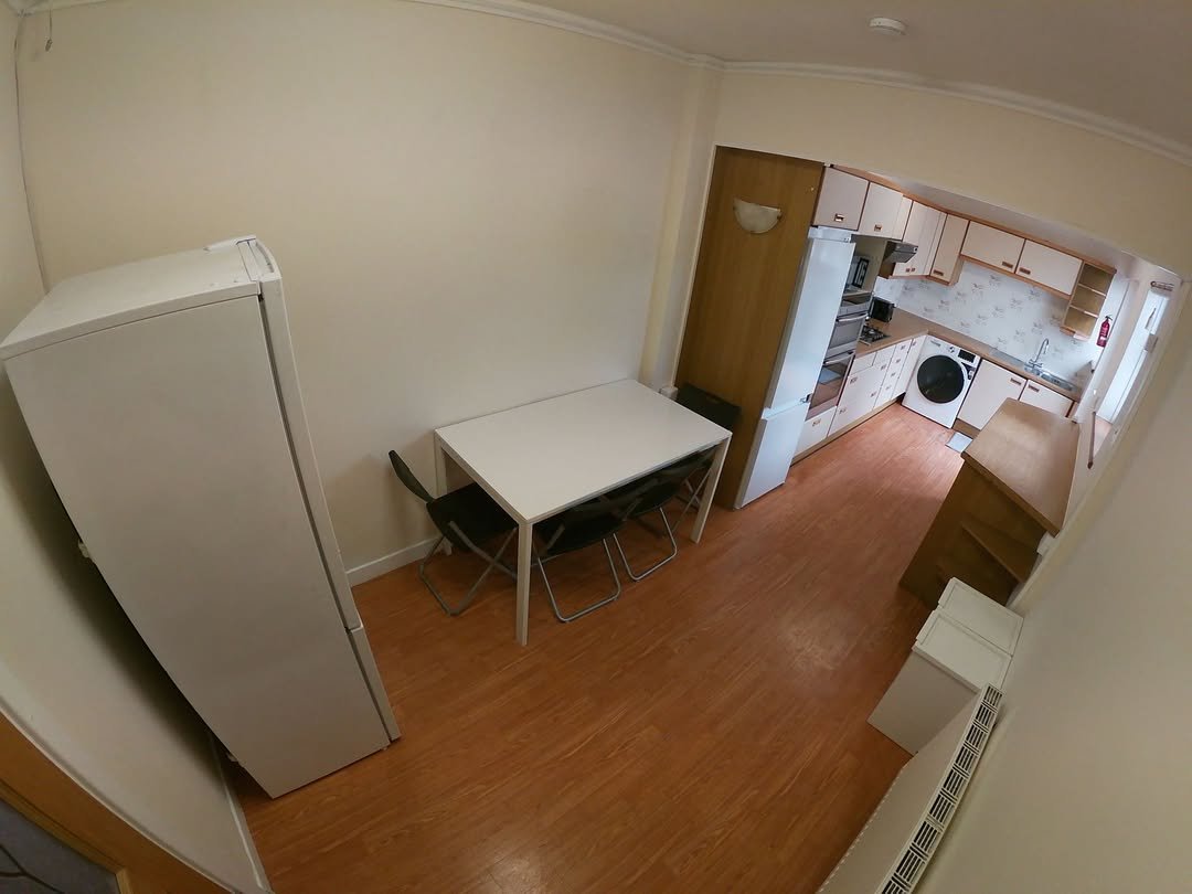Kitchen Dining Area White Appliances Table Kitchen and dining area with white appliances and table setting for four.