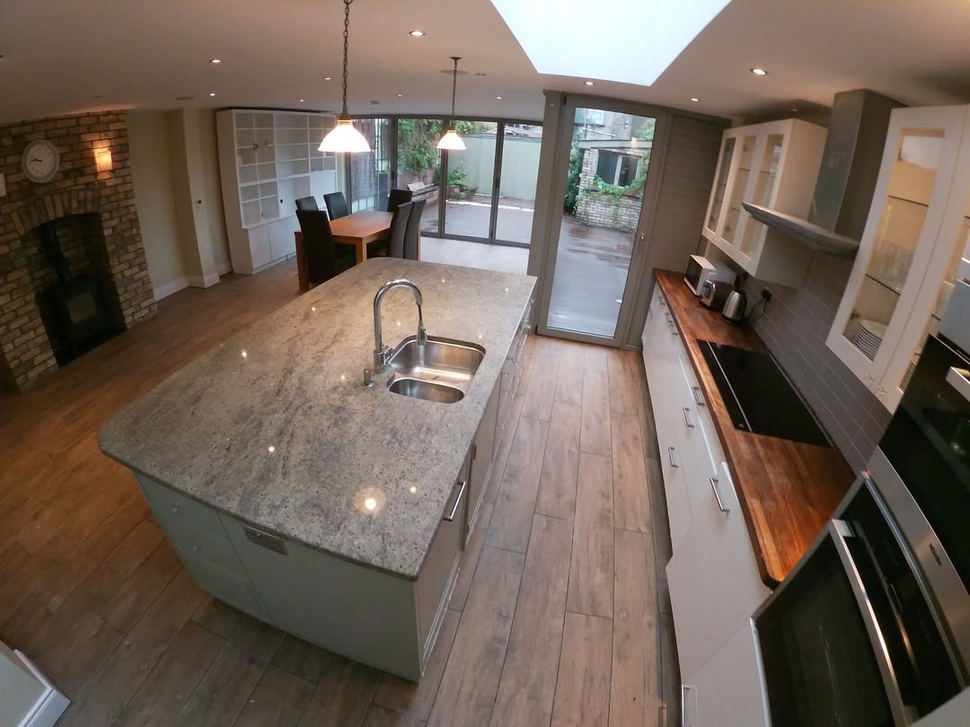 Modern Kitchen Island Open Floorplan Modern kitchen with large island, stainless steel appliances, and open floor plan.