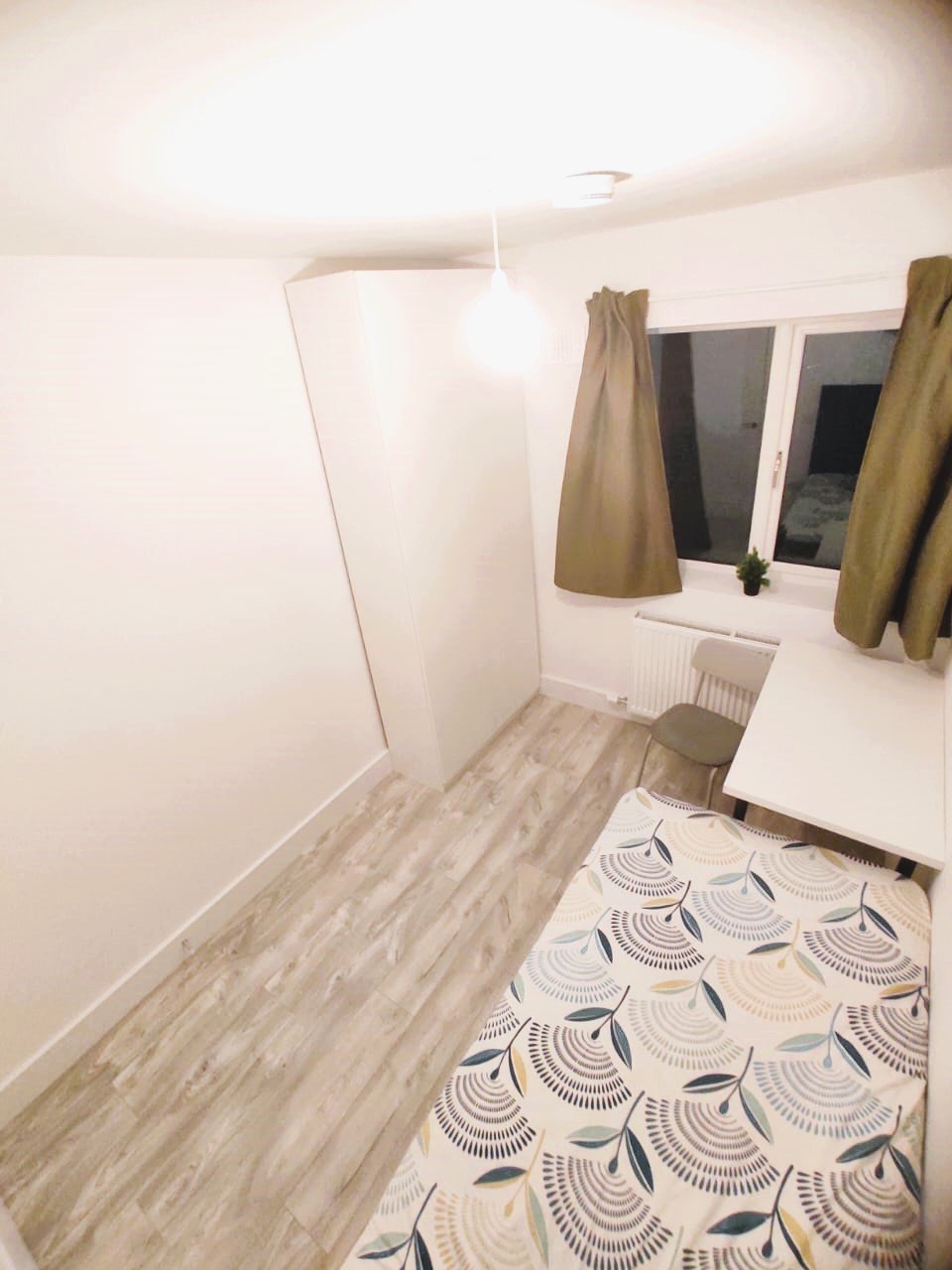 Cozy bedroom with a single bed, wardrobe, desk, and chair. – Ghar.ie property listing
