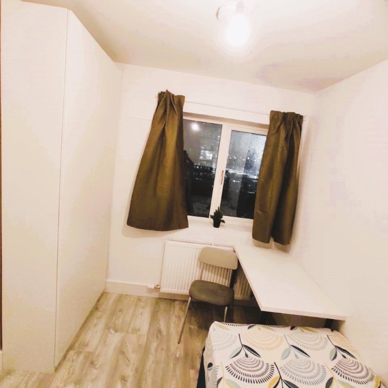 Compact bedroom with desk, chair, bed, and wardrobe near window. – Ghar.ie property listing
