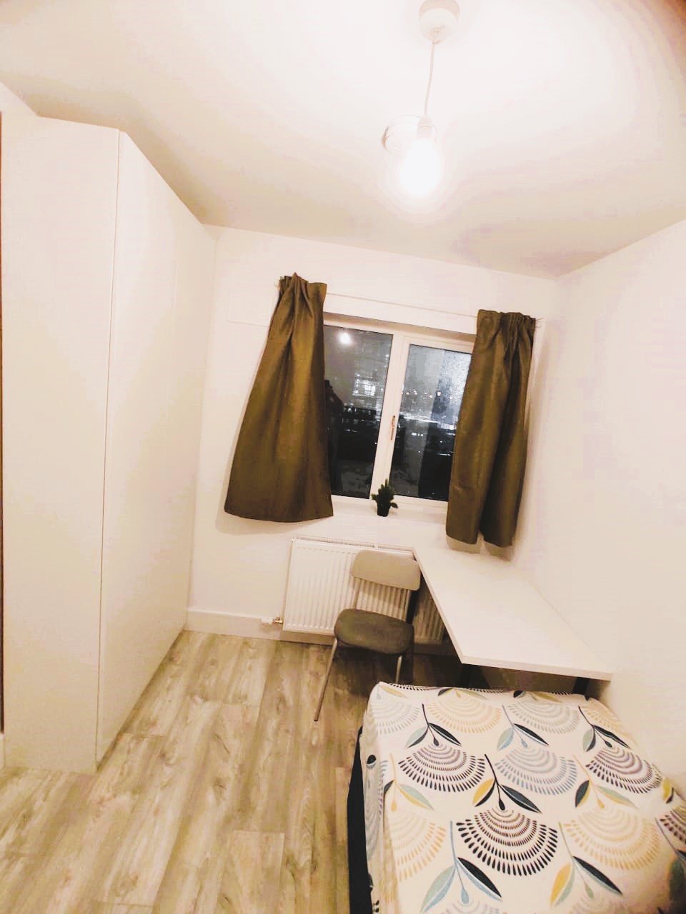 Compact bedroom with desk, chair, bed, and wardrobe near window. – Ghar.ie property listing