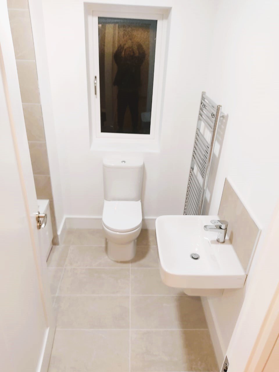 Modern bathroom with toilet, sink, and heated towel rail. – Ghar.ie property listing