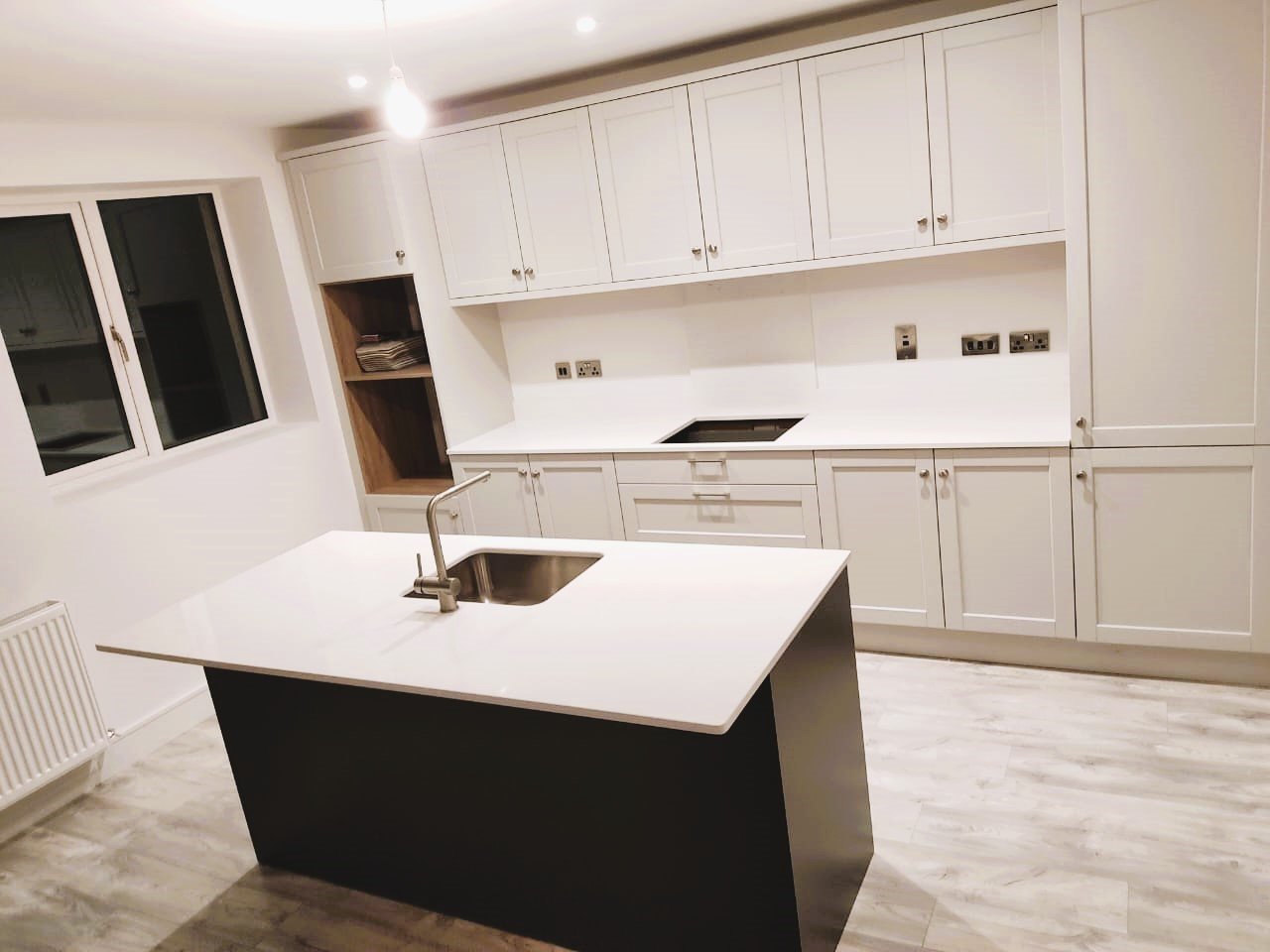 Modern grey kitchen with island, white countertops, and light wood flooring. – Ghar.ie property listing