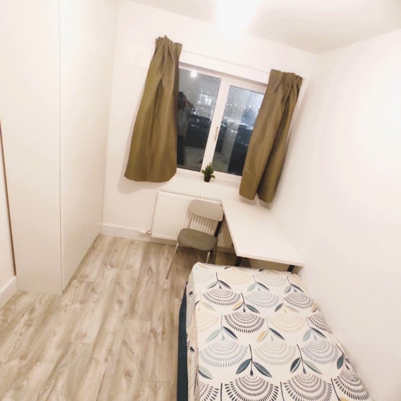 Cozy single bedroom with a bed, desk, chair, and window with curtains. – Ghar.ie property listing