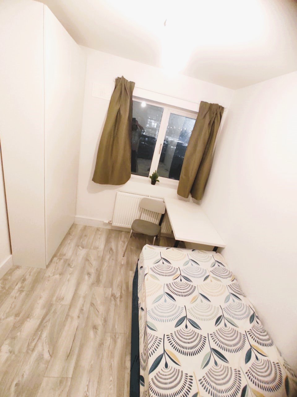 Cozy single bedroom with a bed, desk, chair, and window with curtains. – Ghar.ie property listing